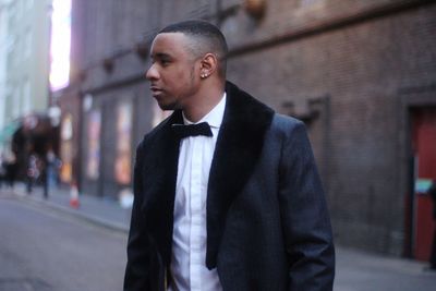 Young man looking away in city