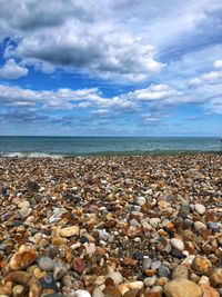 Pebbles on beach against sky