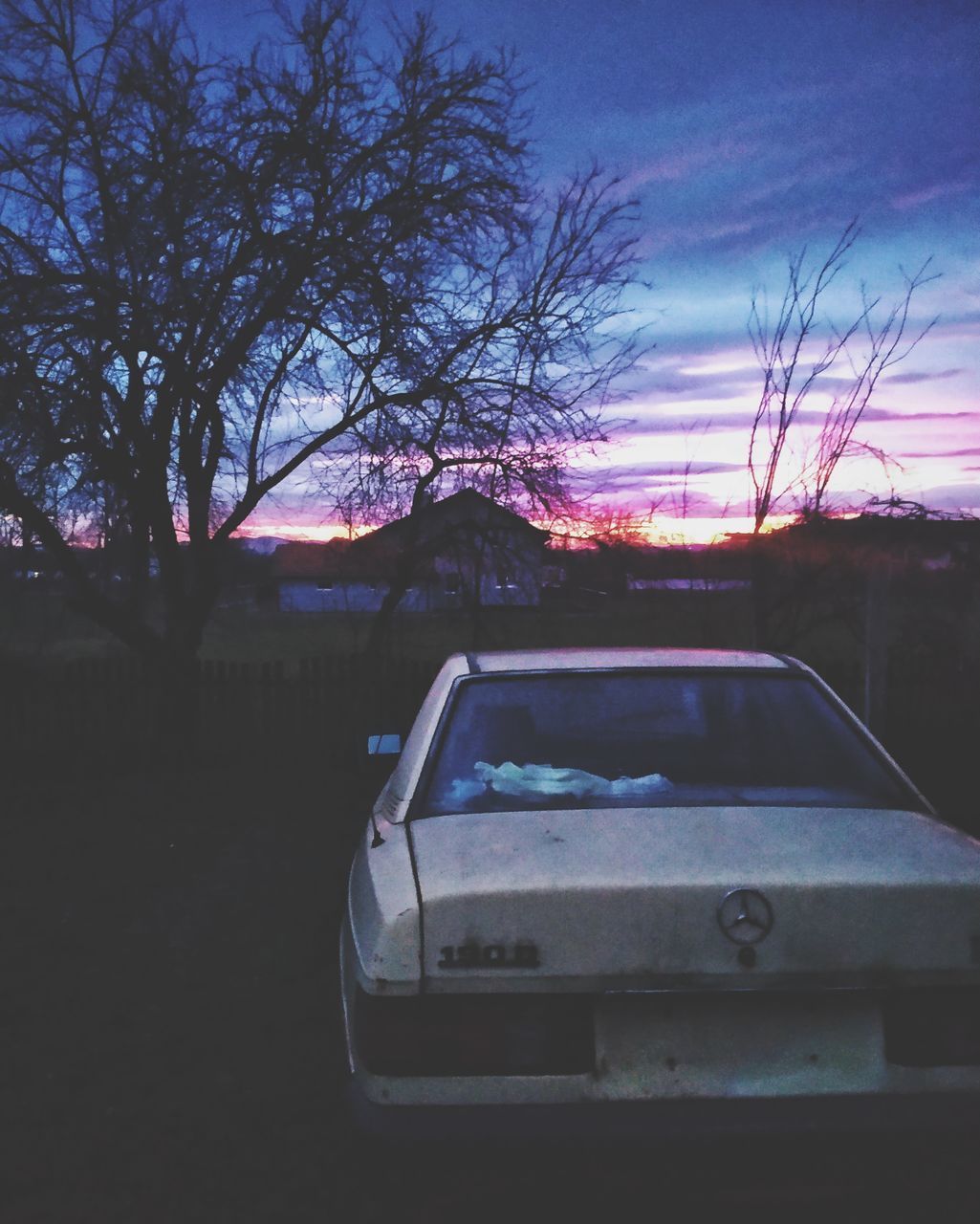 SILHOUETTE OF CAR AGAINST SKY AT SUNSET