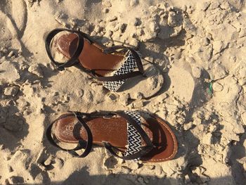 High angle view of sandals on sand at beach