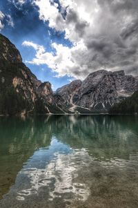 Calm lake against mountain range