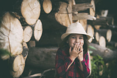 Portrait of girl by logs