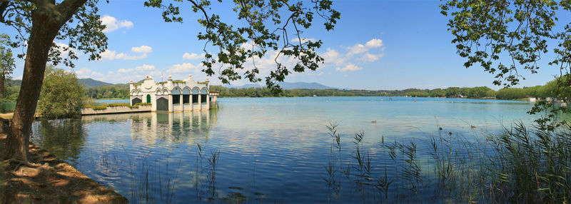 Calm lake with trees in background