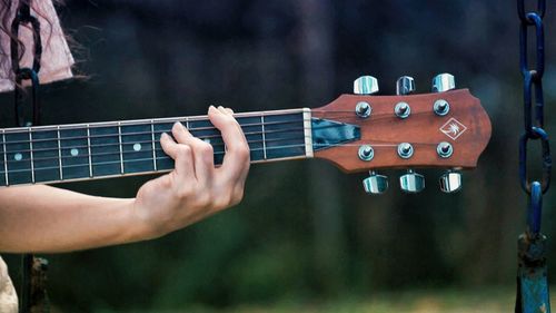 Close-up of hand playing guitar