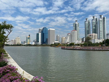 River by buildings against sky in city