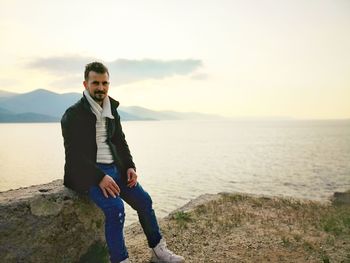 Full length of man standing by sea against sky