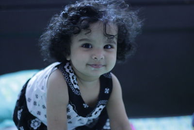 Portrait of baby girl with curly hair