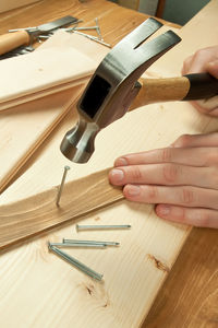 Close-up of hand working on table