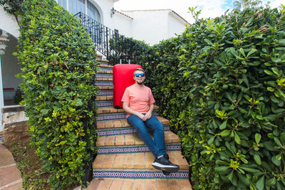 Midsection of man with red plants