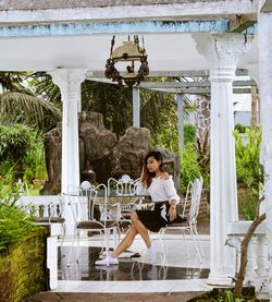 Portrait of smiling woman sitting outdoors