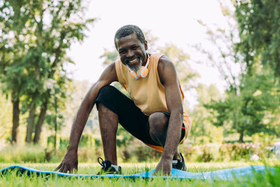 Portrait of smiling man against trees