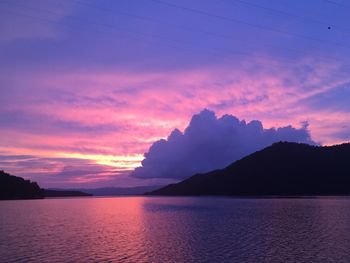 Scenic view of sea against romantic sky at sunset