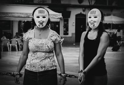 Full length of mask standing in front of man