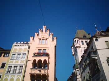 Low angle view of buildings against clear blue sky