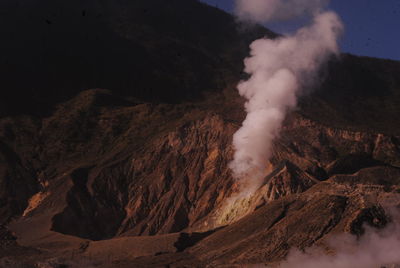 Smoke emitting from volcanic mountain