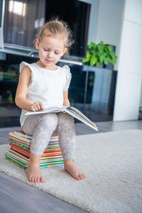 Portrait of cute boy sitting on chair at home