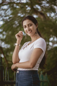 Portrait of smiling young woman standing outdoors