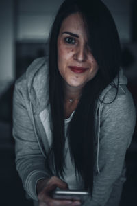 Portrait of beautiful young woman using smart phone