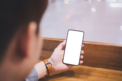 Midsection of man using mobile phone