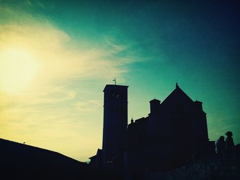 Low angle view of silhouette buildings against sky