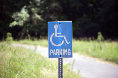 Close up of a blue accessible handicap parking sign