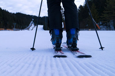 Low angle view of person skiing on snow covering field