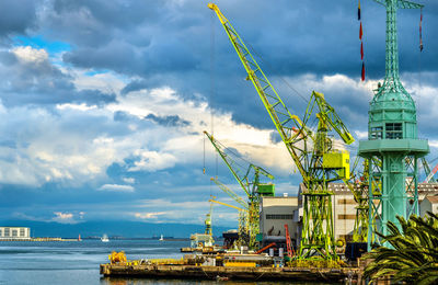 Commercial dock by sea against sky