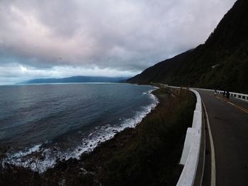 Panoramic view of road by sea against sky