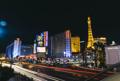 Illuminated cityscape against clear sky at night