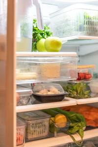 Neatly organized open refrigerator stocked with healthy food