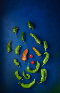 Directly above shot of chili peppers on blue background