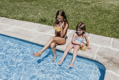 Women sitting in swimming pool