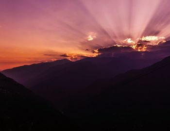 Scenic view of silhouette mountains against sky during sunset