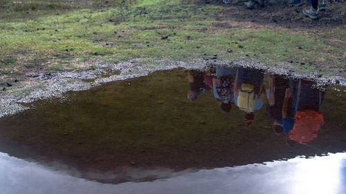 High angle view of people walking on puddle