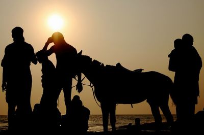 Silhouette people at sunset