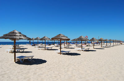 Lounge chairs and umbrellas on beach