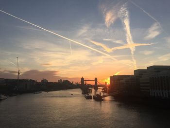 Mid distance over tower bridge over thames river against sky during sunset