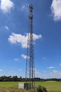 Low angle view of communications tower against sky