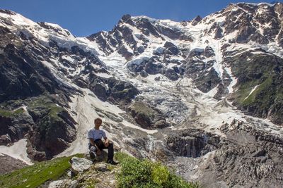 Portrait of hiker sitting at rocky mountain