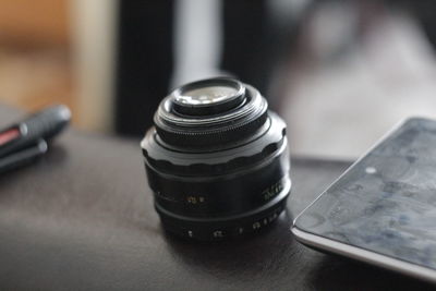 Close-up of lens by digital tablet on table