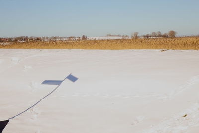 Scenic view of snowy field against clear sky