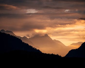 Scenic view of silhouette mountains against sky during sunset