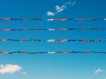 Low angle view of decoration against blue sky