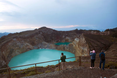 Tourists who are waiting for the sunrise at lake kelimutu, flores