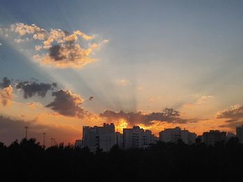 Silhouette of city at sunset