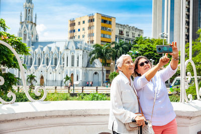 Senior mother and daugther travelling togeher having fun. senior adults in cali colombia. 