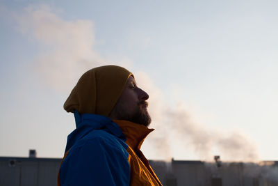 Low angle view of man standing against sky