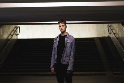 Full length of young man standing in an underground crosswalk