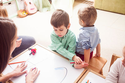 Boy drawing on paper at home