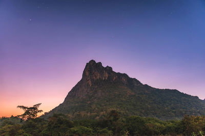 Scenic view of mountains against sky at night